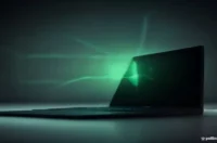 Dark desk with a black laptop showing a bright green terminal and subtle neon circuit accents, minimal background.